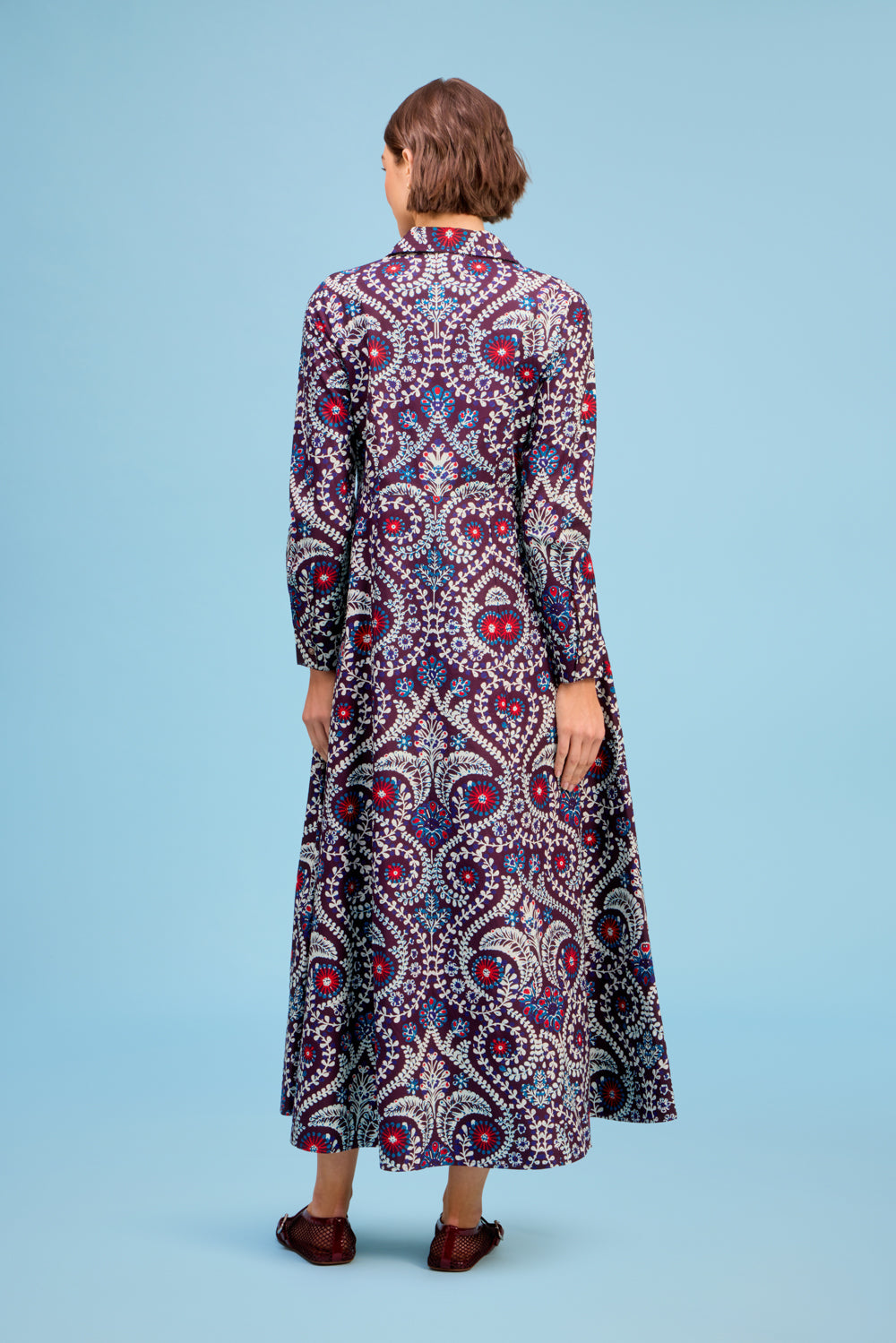 Model wearing Livro Classic Shirtdress in Scroll, back view.