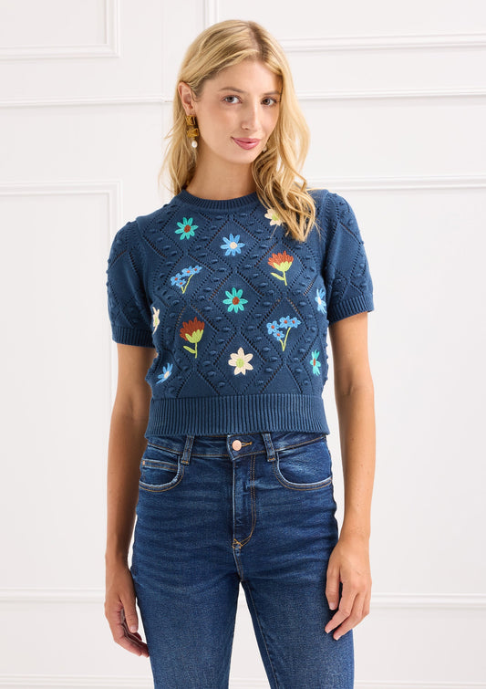 Model wearing Alivia navy floral embroidered Nora Sweater