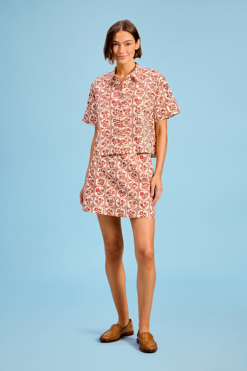 Model wearing Livro The Mini Skirt in Brick Bloom, front view