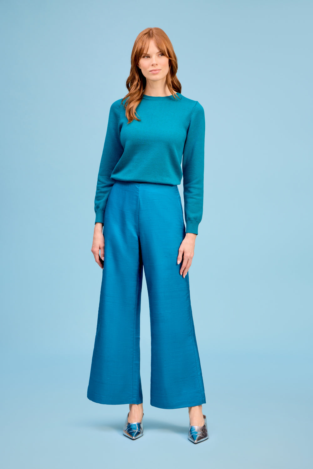 Model wearing Livro Paloma Pant in teal, front detail.